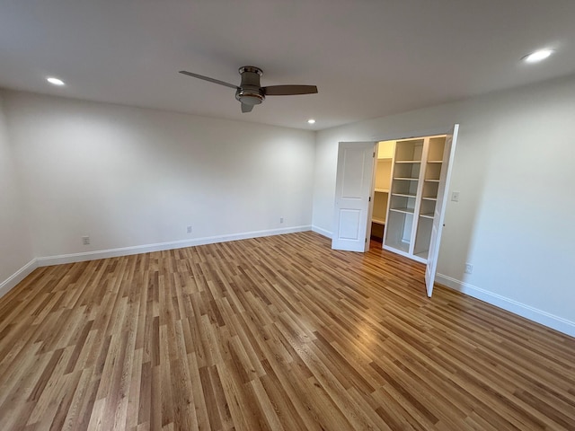 unfurnished room featuring ceiling fan and light wood-type flooring