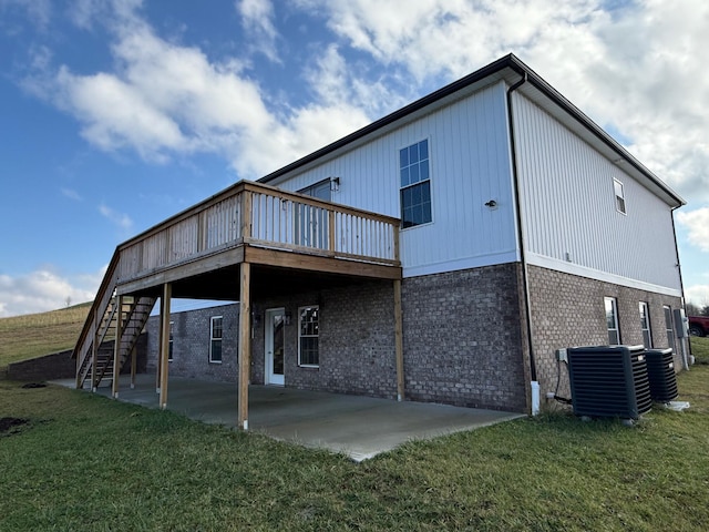 back of house featuring a patio, a yard, central AC unit, and a wooden deck