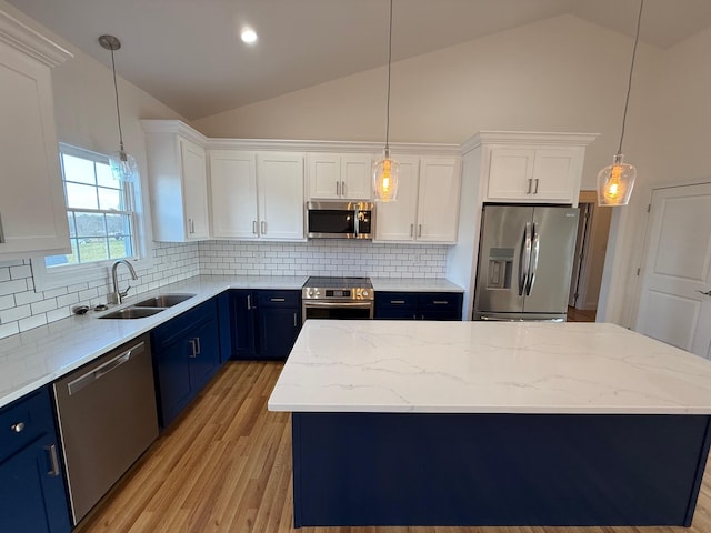 kitchen featuring white cabinetry, sink, blue cabinetry, and appliances with stainless steel finishes