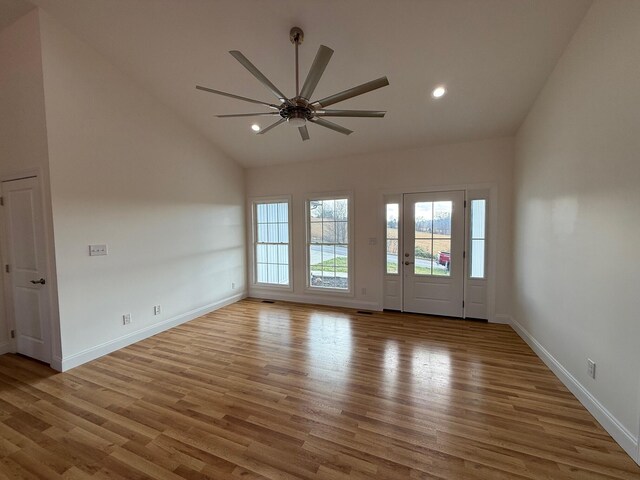 spare room featuring ceiling fan, vaulted ceiling, and light hardwood / wood-style flooring