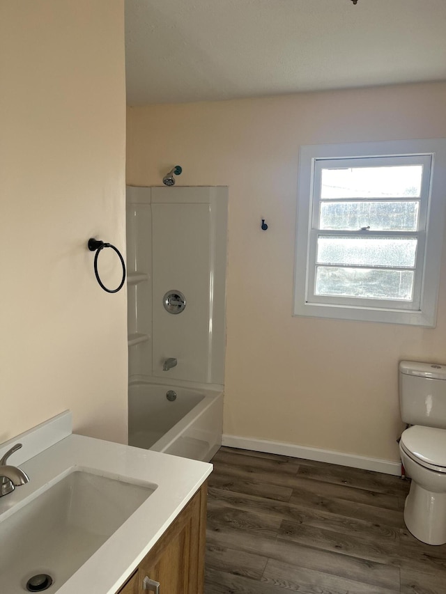 full bathroom with wood-type flooring, toilet, vanity, and  shower combination