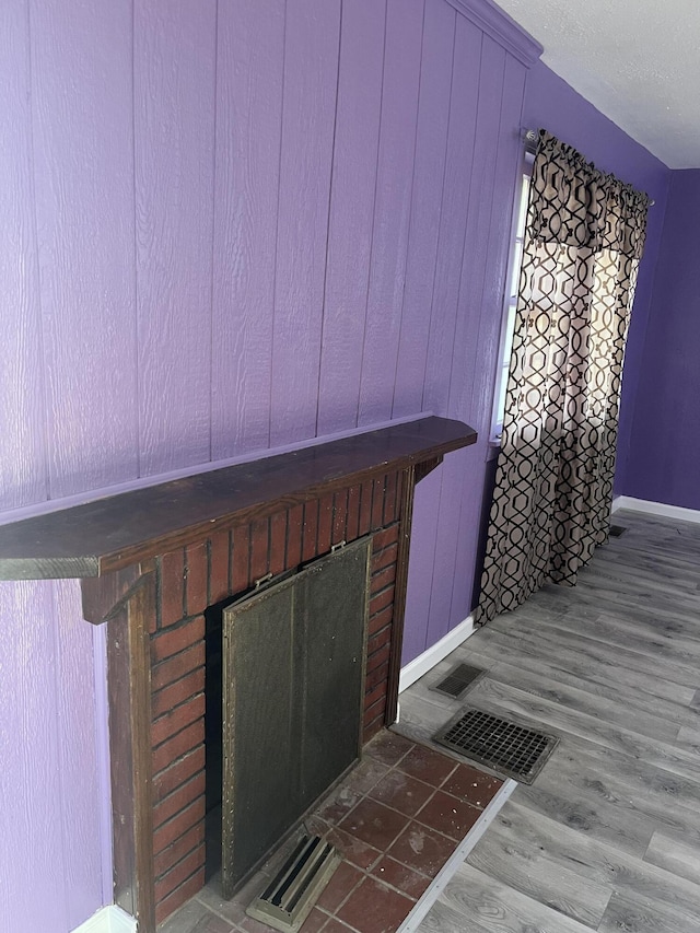 interior details featuring a fireplace and hardwood / wood-style flooring