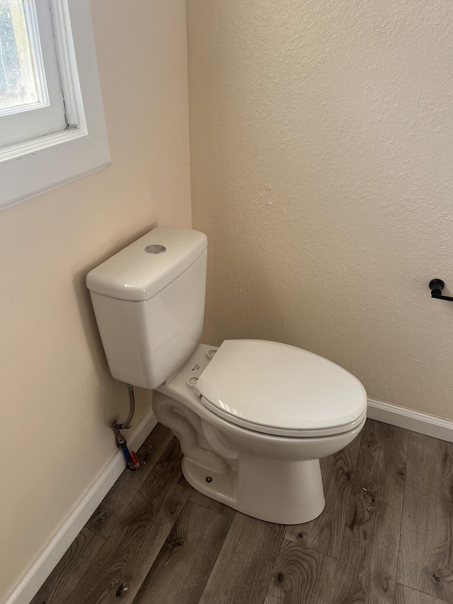 bathroom with toilet and hardwood / wood-style flooring