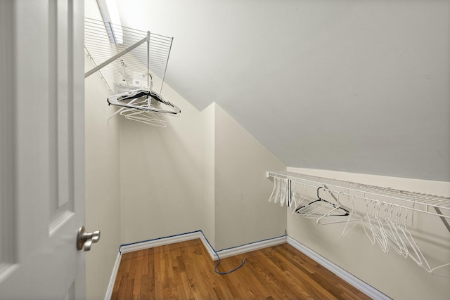 spacious closet featuring hardwood / wood-style floors and lofted ceiling