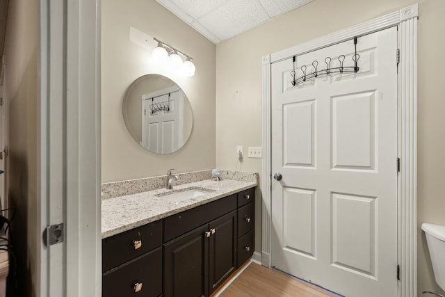 bathroom featuring hardwood / wood-style floors, vanity, and toilet