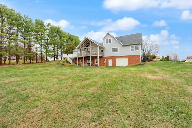 back of house with a yard, a deck, and a garage