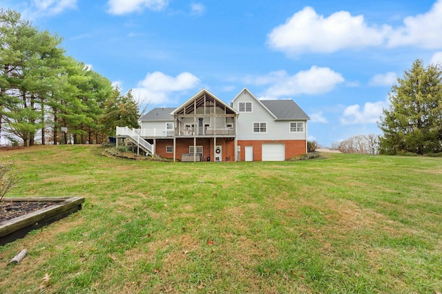 rear view of property featuring a yard, a deck, and a garage