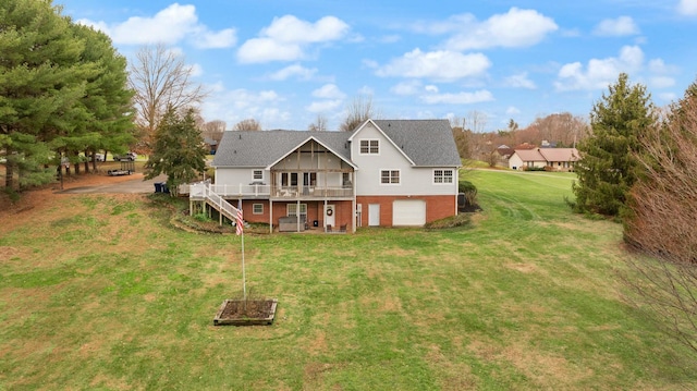 back of house featuring a garage, a deck, and a yard