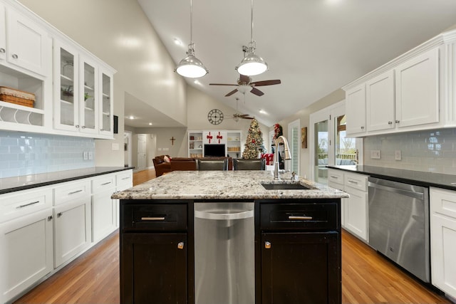 kitchen featuring stainless steel dishwasher, ceiling fan, sink, a center island with sink, and hanging light fixtures