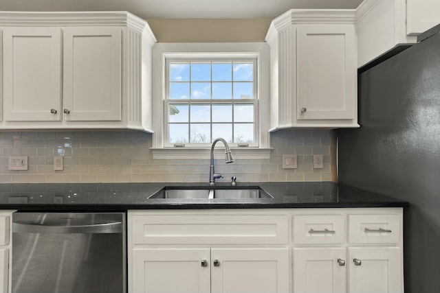 kitchen featuring dishwasher, tasteful backsplash, white cabinetry, and sink