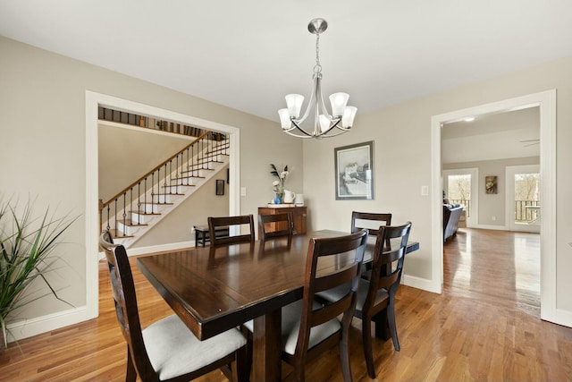 dining space with a chandelier and light wood-type flooring