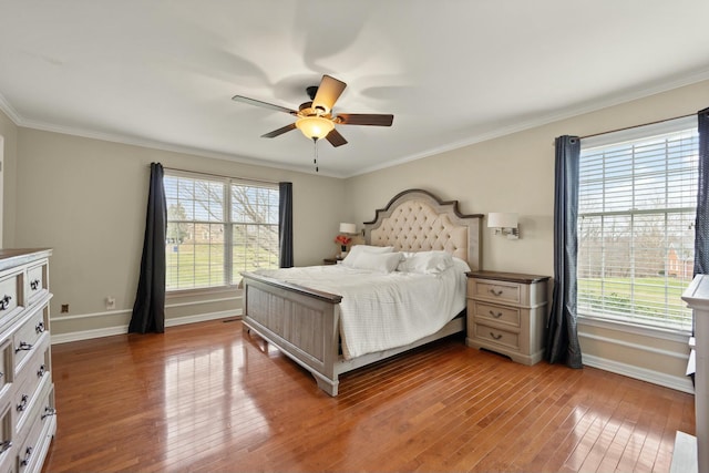 bedroom featuring ceiling fan, crown molding, and hardwood / wood-style flooring