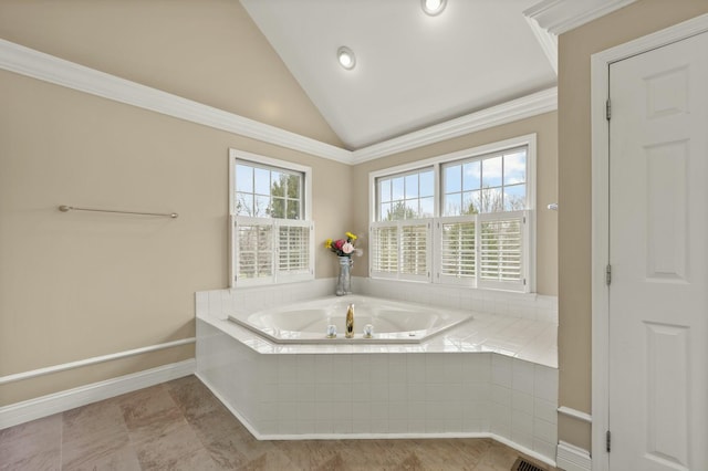 bathroom featuring a relaxing tiled tub, vaulted ceiling, and ornamental molding