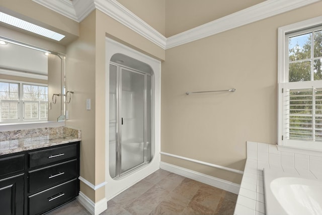 bathroom with plenty of natural light, shower with separate bathtub, vanity, and a skylight