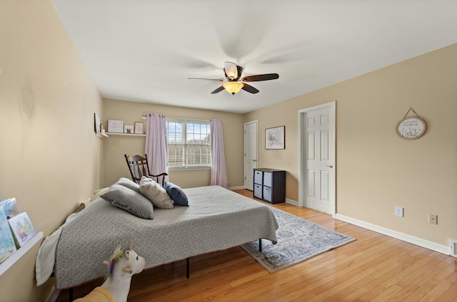 bedroom with ceiling fan and light hardwood / wood-style floors