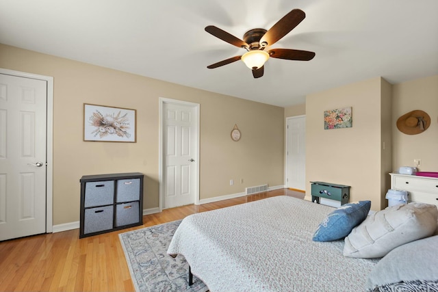 bedroom with light hardwood / wood-style floors and ceiling fan