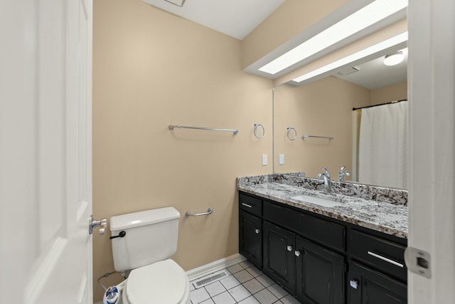 bathroom with tile patterned flooring, vanity, and toilet