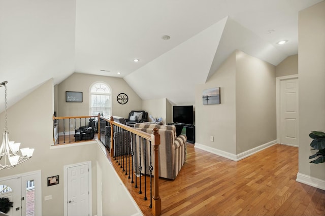 interior space with hardwood / wood-style flooring, lofted ceiling, and a chandelier