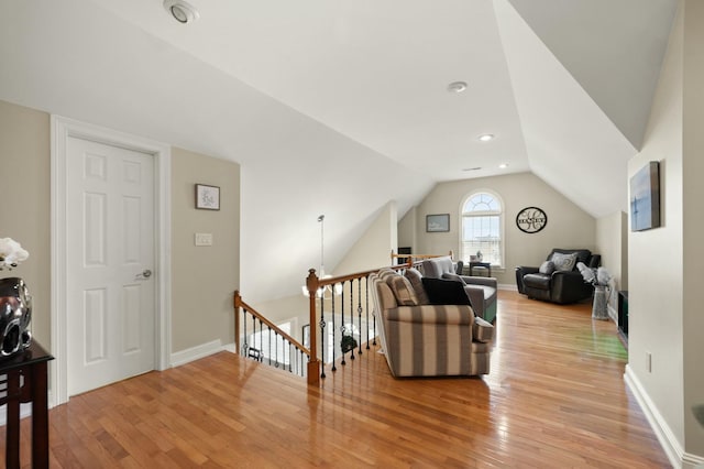 living room featuring light hardwood / wood-style floors and vaulted ceiling