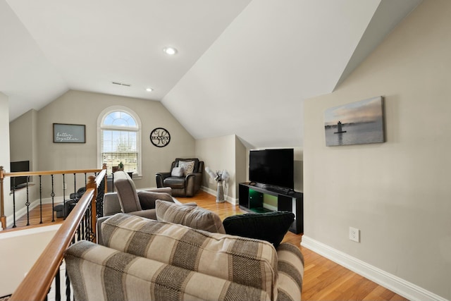 living room with light hardwood / wood-style floors and lofted ceiling