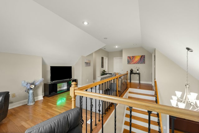 interior space with hardwood / wood-style floors, a chandelier, and vaulted ceiling