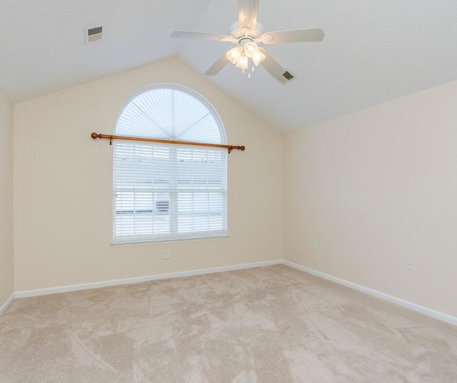 unfurnished room with ceiling fan, light colored carpet, and lofted ceiling