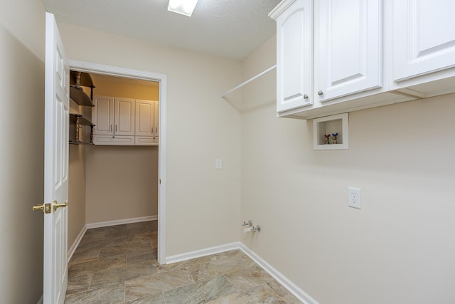 laundry room featuring cabinets and washer hookup