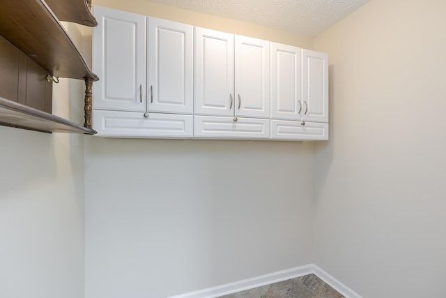 laundry area with a textured ceiling