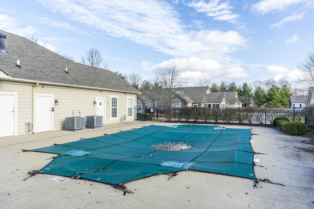 view of pool with central AC unit and a patio