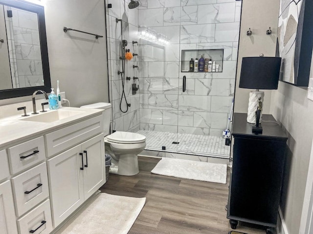 bathroom with vanity, toilet, wood-type flooring, and walk in shower