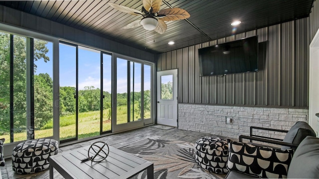 sunroom featuring ceiling fan and a wealth of natural light