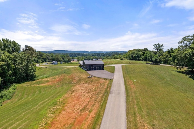 birds eye view of property with a mountain view and a rural view