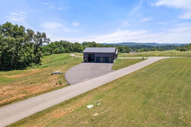 view of front of property featuring a mountain view, a rural view, a front yard, and a carport