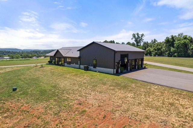 view of property exterior with a carport, a garage, and a yard