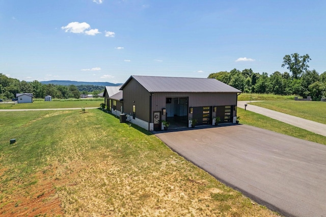 view of front of home with a front yard and a carport