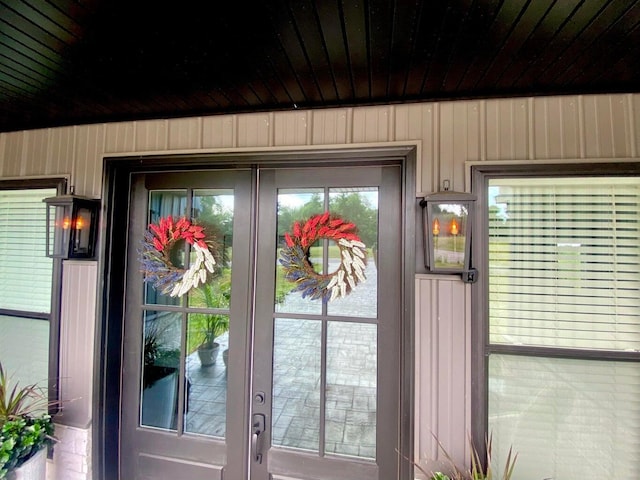 interior space featuring wood walls and french doors