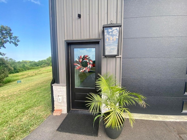 doorway to property featuring a yard