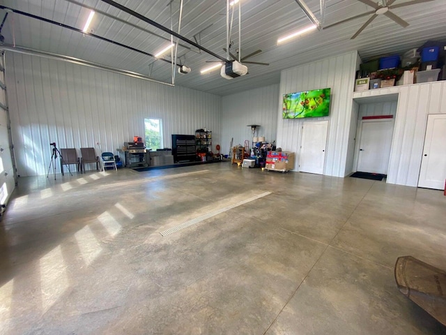 garage with a garage door opener and ceiling fan