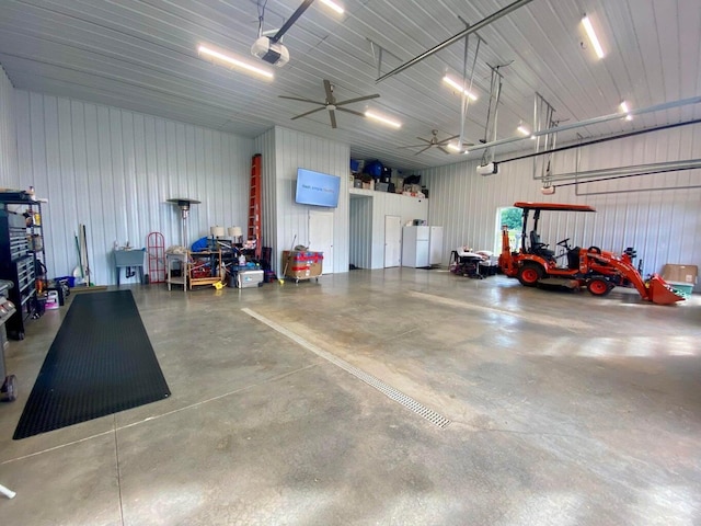 garage featuring a garage door opener and ceiling fan