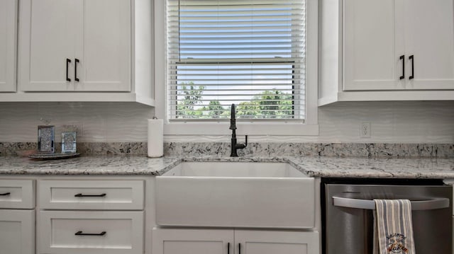 kitchen featuring white cabinets, backsplash, and sink