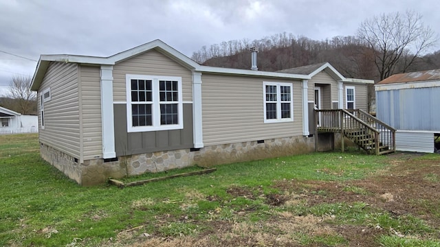 rear view of house with a yard