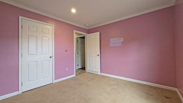 unfurnished bedroom with ornamental molding and light carpet