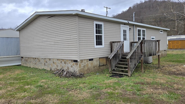 back of house with a lawn