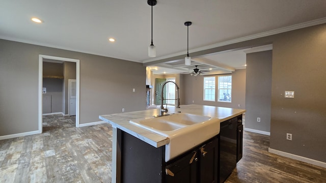 kitchen featuring ceiling fan, dishwasher, sink, decorative light fixtures, and a kitchen island with sink