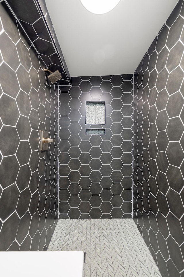 bathroom with tiled shower