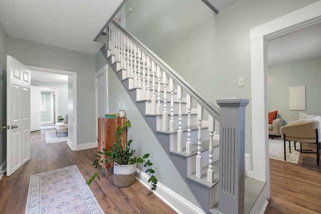 stairs featuring hardwood / wood-style floors