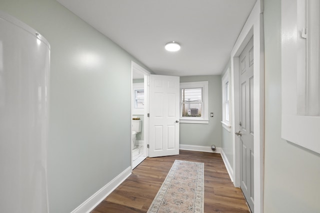 corridor with dark hardwood / wood-style flooring