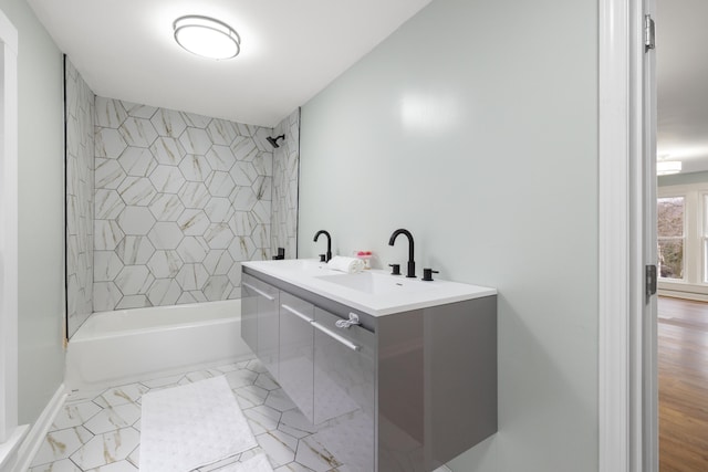 bathroom with vanity and tiled shower / bath