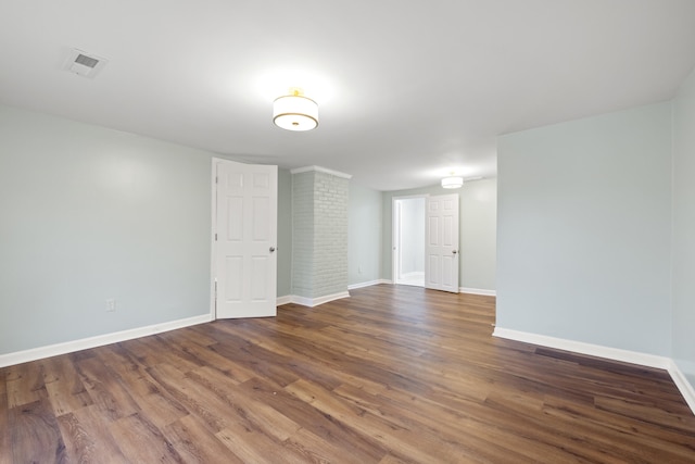 empty room with dark hardwood / wood-style flooring