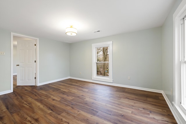 empty room featuring dark hardwood / wood-style flooring